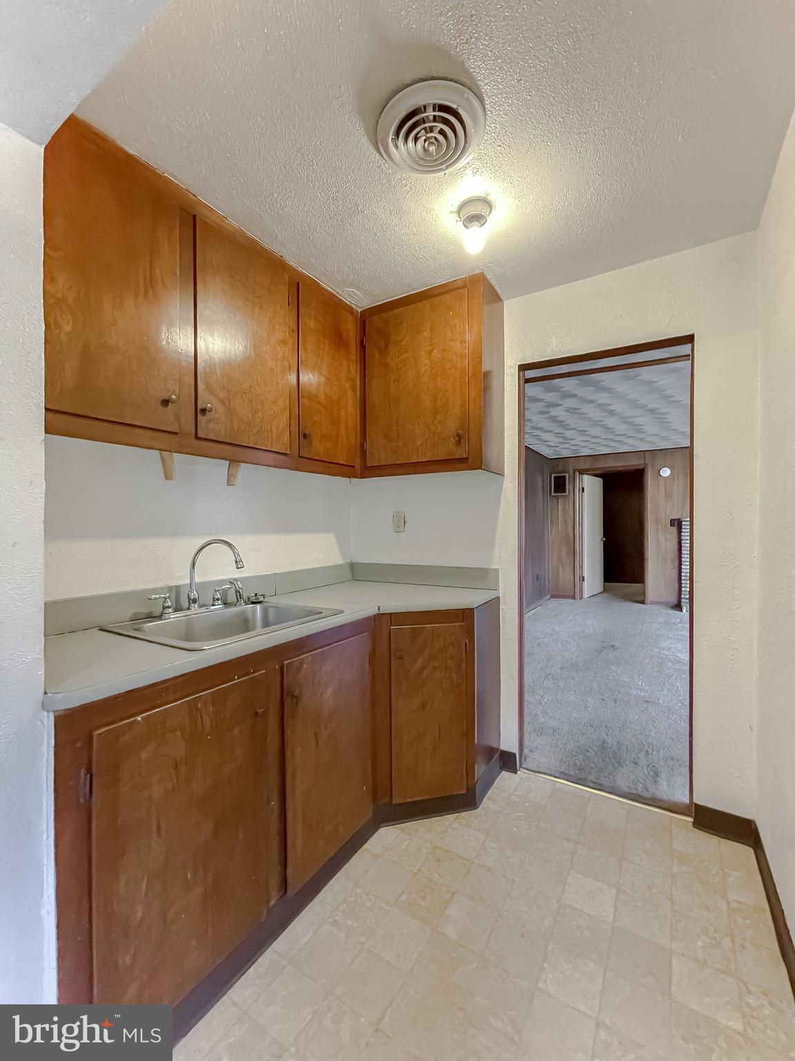 1 Prospect Avenue Indian Head, MD 20640 - Photo 31 of 44 a kitchen with granite countertop a sink a stove and cabinets