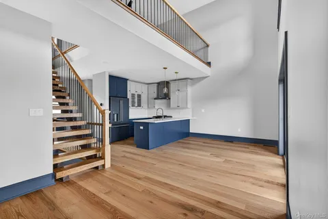 a view of kitchen and hall with wooden floor