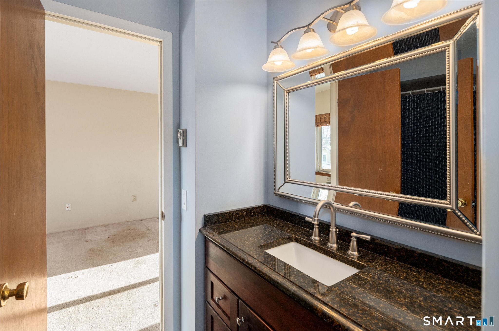 950 Cove Road, Unit B6 Stamford, CT 06902 - Photo 27 of 34 a bathroom with a granite countertop sink and a mirror