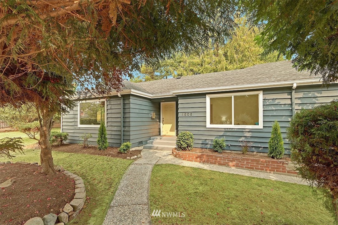 4606 South Adams Street Seattle, WA 98118 - Photo 1 of 29 a front view of a house with a yard