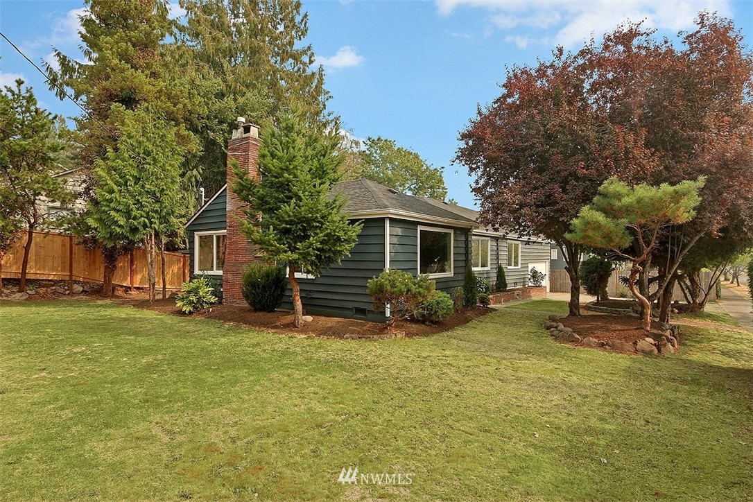 4606 South Adams Street Seattle, WA 98118 - Photo 2 of 29 a view of a house with a yard and trees