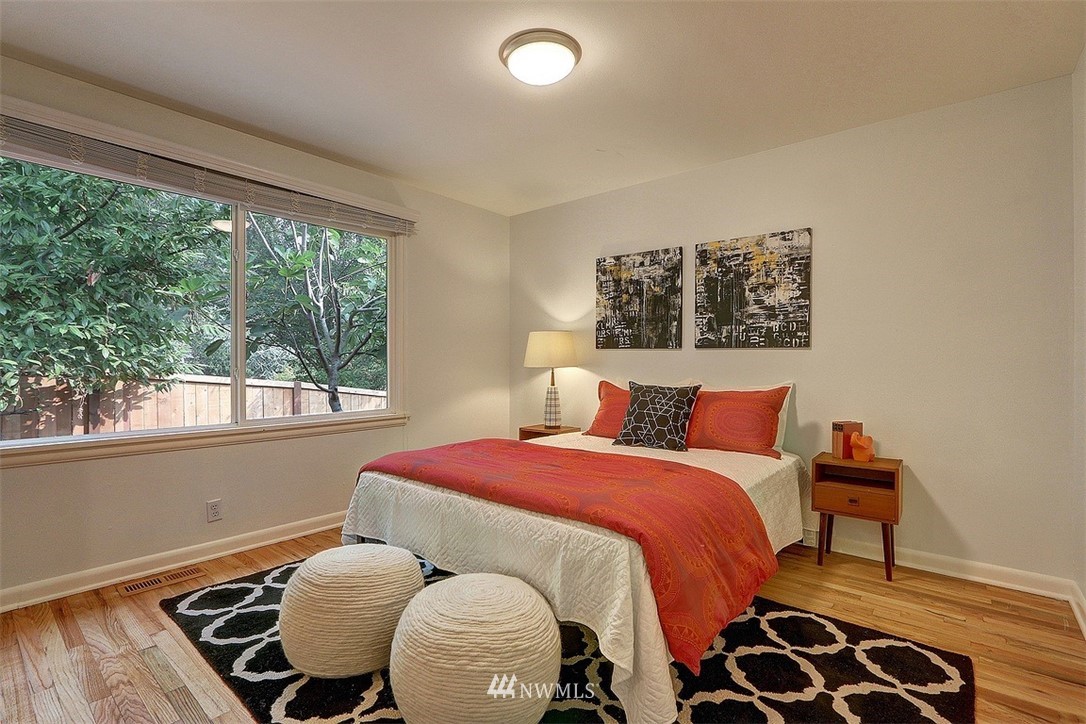 4606 South Adams Street Seattle, WA 98118 - Photo 12 of 29 a bedroom with a bed and wooden floor