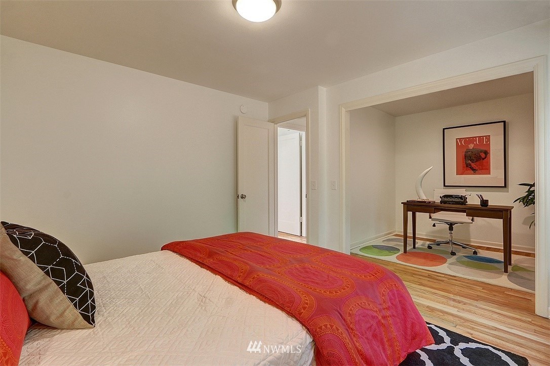 4606 South Adams Street Seattle, WA 98118 - Photo 13 of 29 a bedroom with a bed a desk and chair