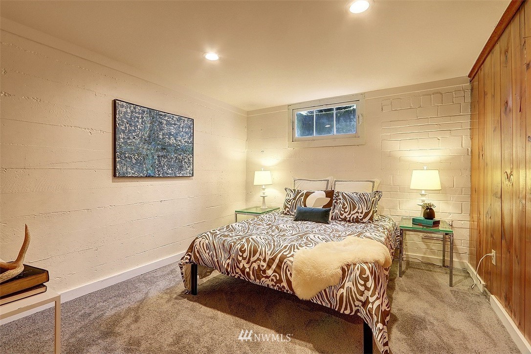 4606 South Adams Street Seattle, WA 98118 - Photo 23 of 29 a bedroom with a bed and a night stand