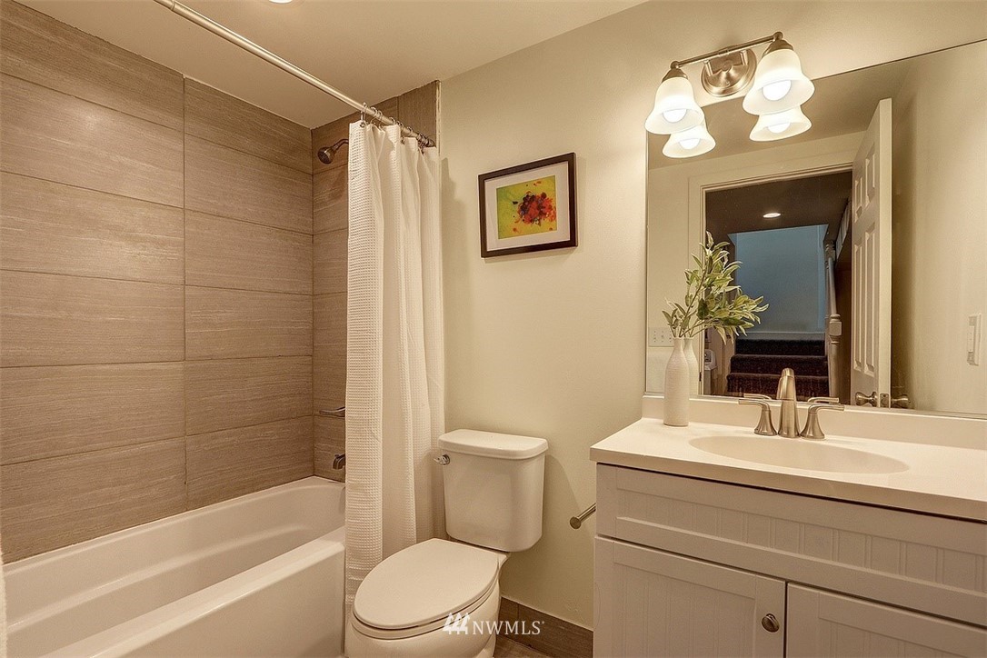 4606 South Adams Street Seattle, WA 98118 - Photo 24 of 29 a bathroom with a sink a toilet and shower