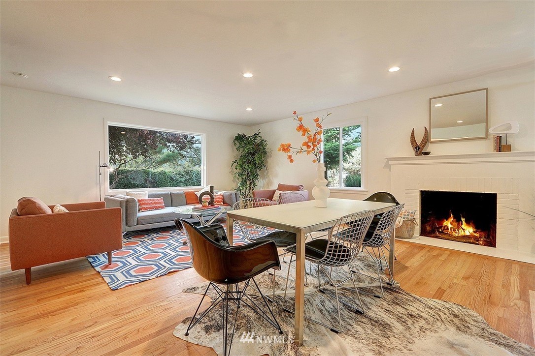 4606 South Adams Street Seattle, WA 98118 - Photo 9 of 29 a living room with furniture a fireplace and a table