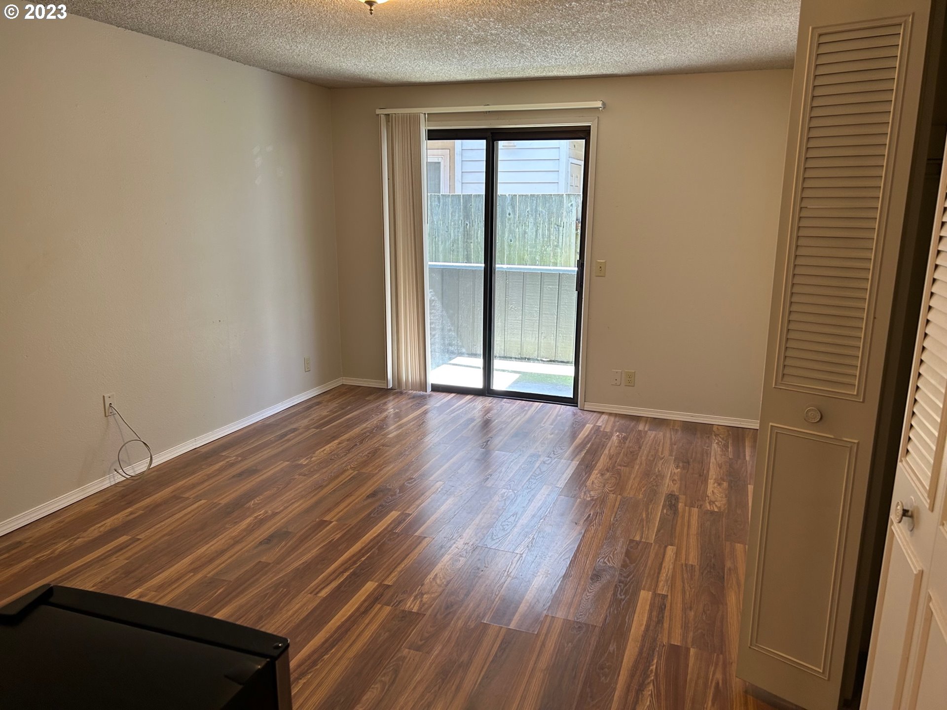 1640 Mill Street Eugene, OR 97401 - Photo 6 of 12 a view of an empty room with wooden floor and a window