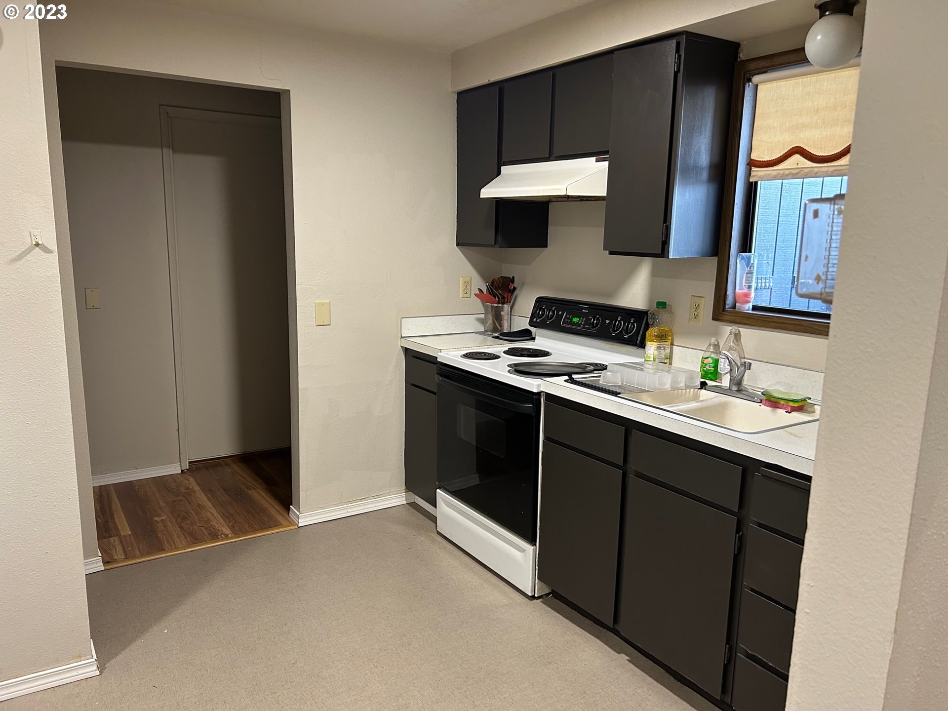 1640 Mill Street Eugene, OR 97401 - Photo 7 of 12 a kitchen with stainless steel appliances a stove a sink and a microwave