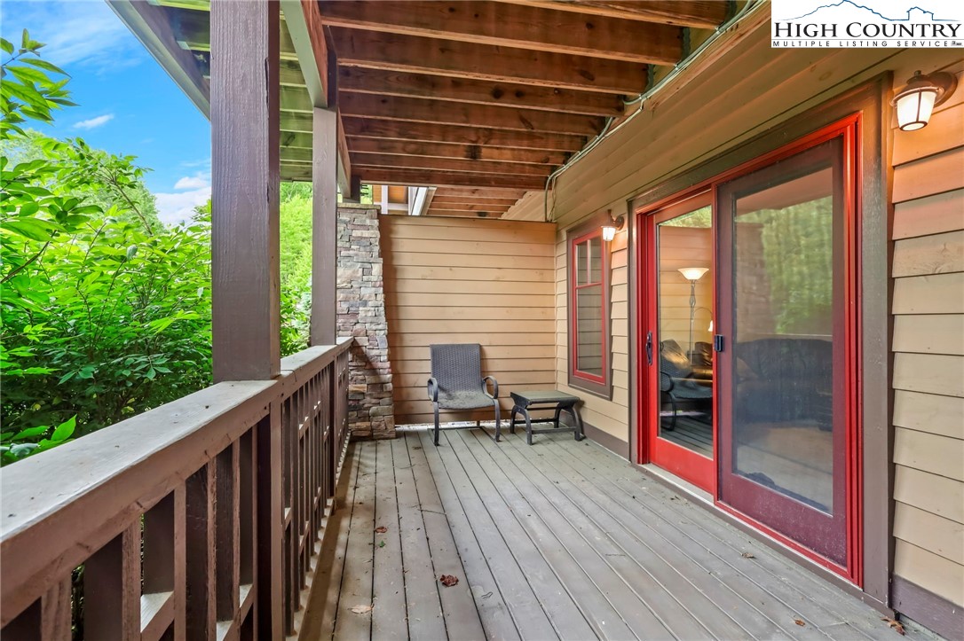138 South Camp Road, Unit 103 Boone, NC 28607 - Photo 44 of 50 a balcony with furniture and wooden floor