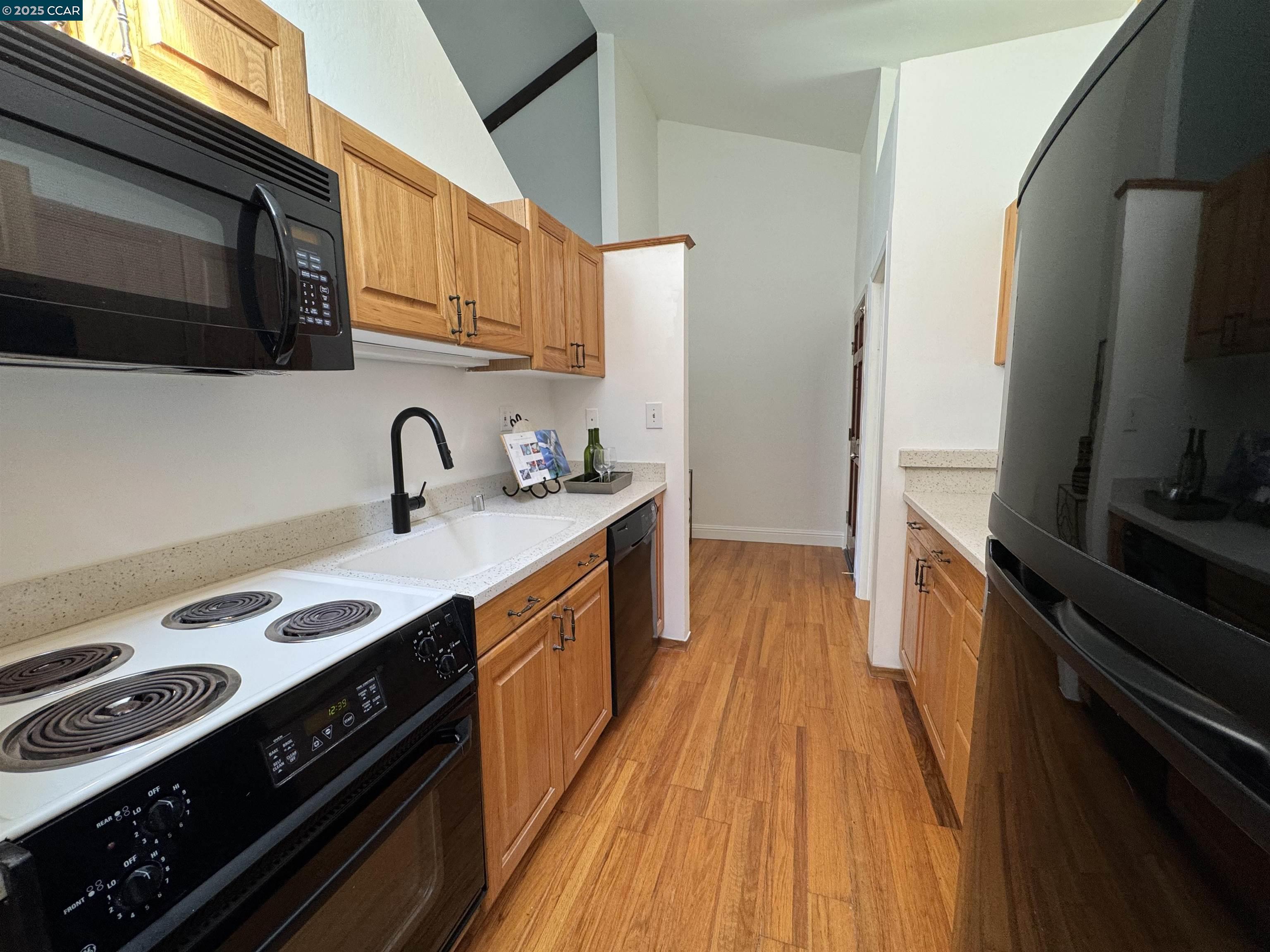 2075 Ascot Drive, Unit 221 Moraga, CA 94556 - Photo 12 of 21 a kitchen with stainless steel appliances a sink a stove and a microwave