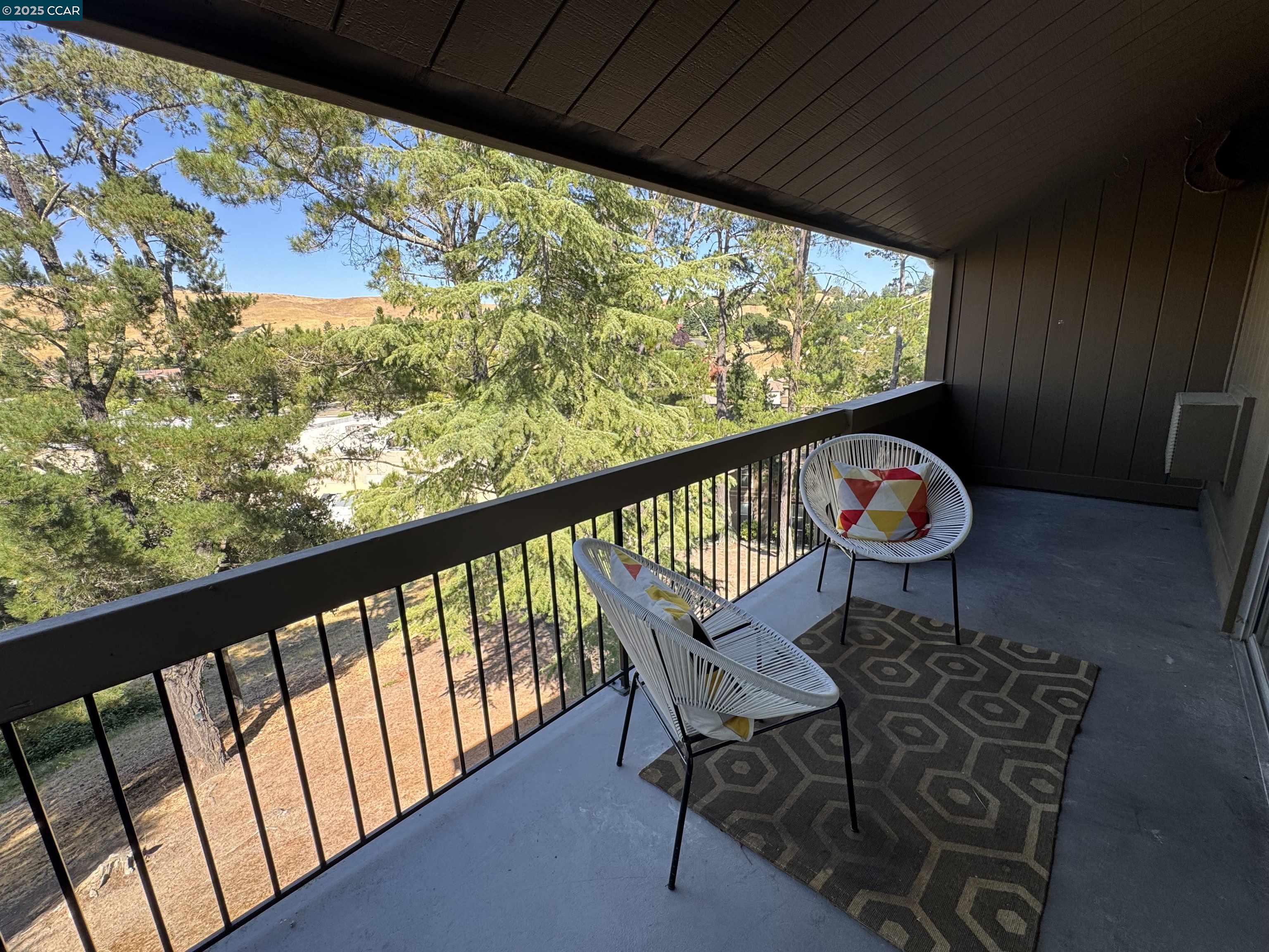 2075 Ascot Drive, Unit 221 Moraga, CA 94556 - Photo 20 of 21 a view of a two chairs and table in the balcony