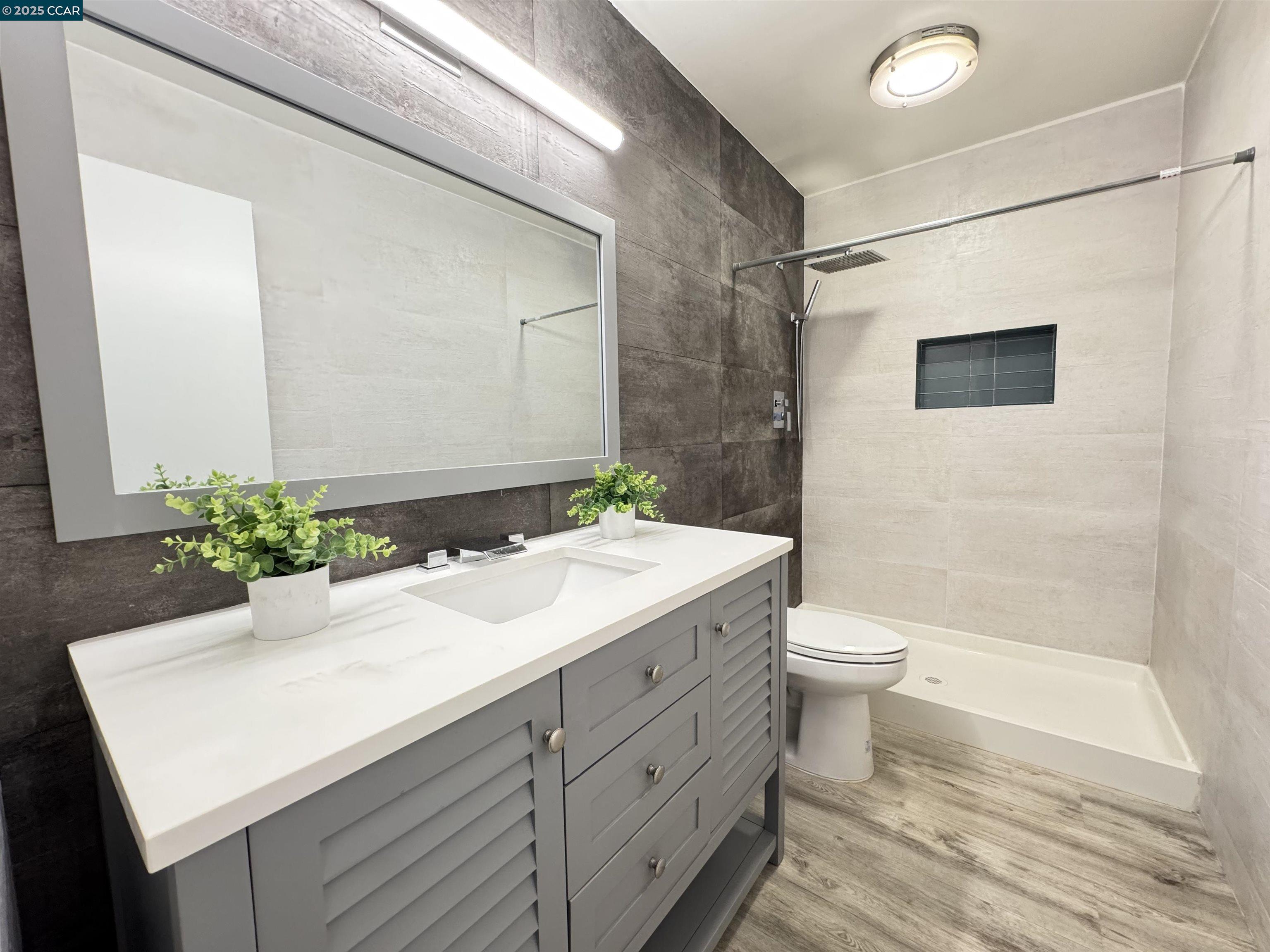 2075 Ascot Drive, Unit 221 Moraga, CA 94556 - Photo 6 of 21 a bathroom with a sink a toilet and shower