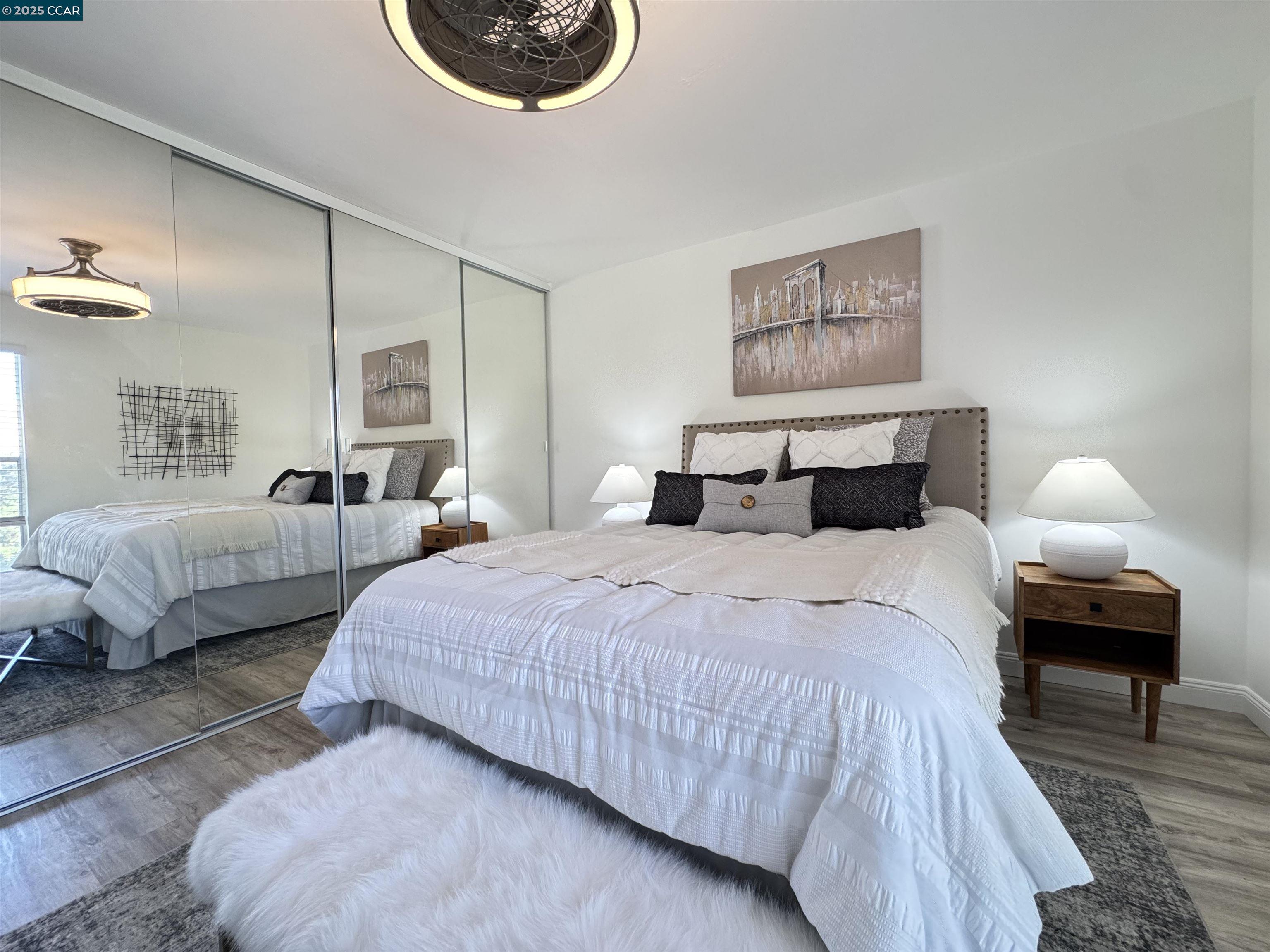 2075 Ascot Drive, Unit 221 Moraga, CA 94556 - Photo 7 of 21 a bedroom with bed and a lamp