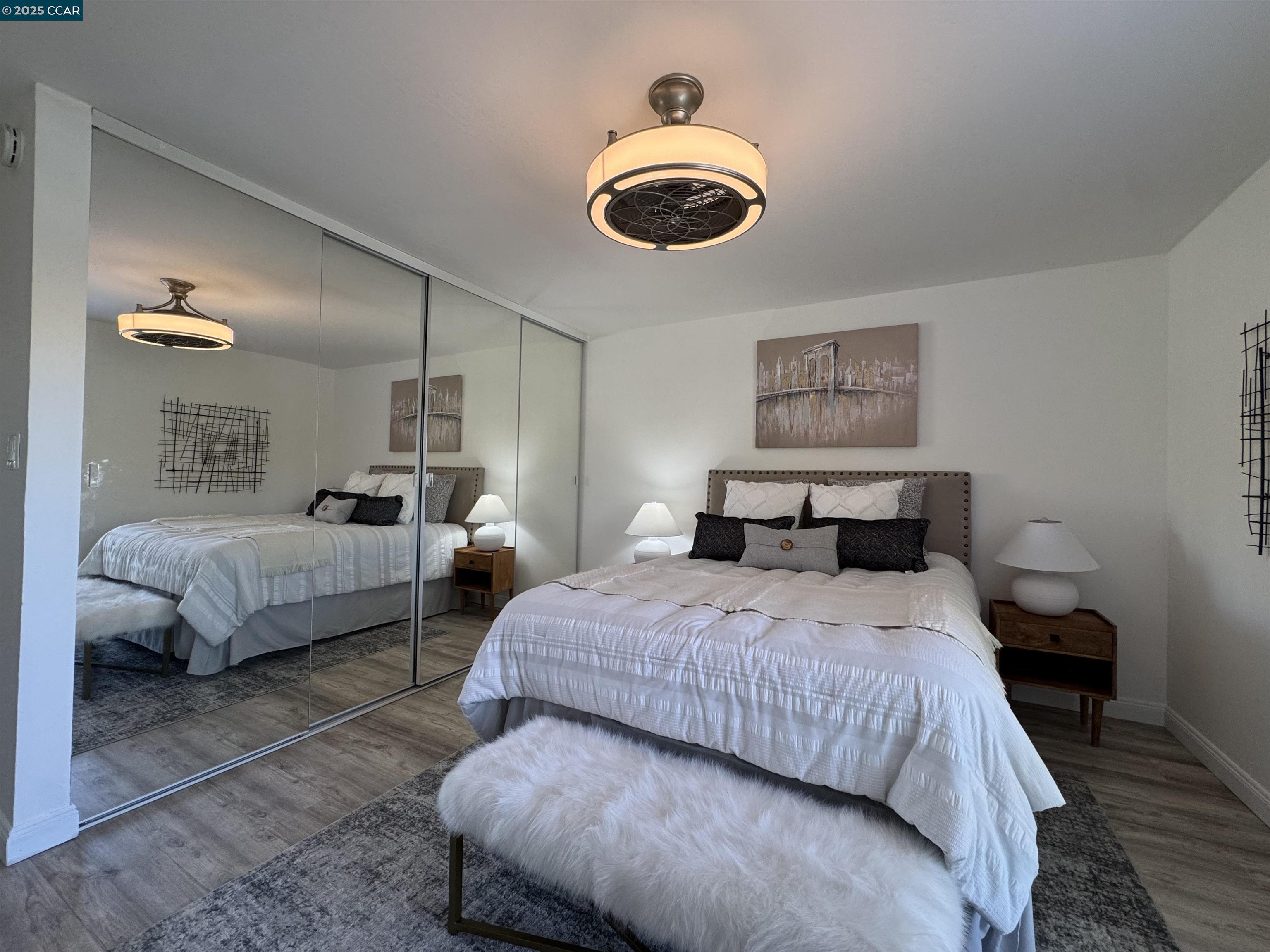 2075 Ascot Drive, Unit 221 Moraga, CA 94556 - Photo 8 of 21 a bedroom with bed and a chandelier