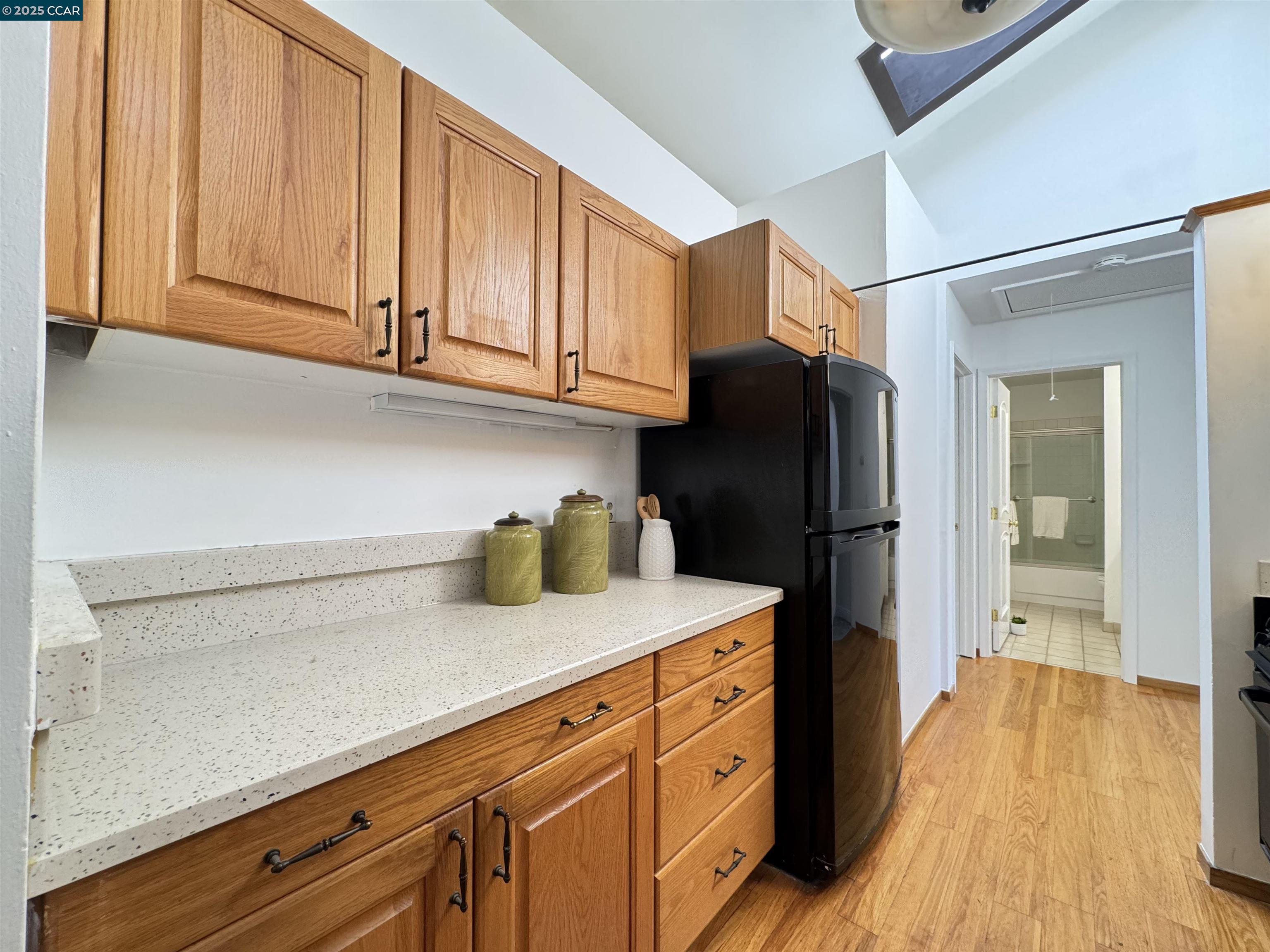 2075 Ascot Drive, Unit 221 Moraga, CA 94556 - Photo 10 of 21 a kitchen with granite countertop stainless steel appliances a refrigerator and cabinets