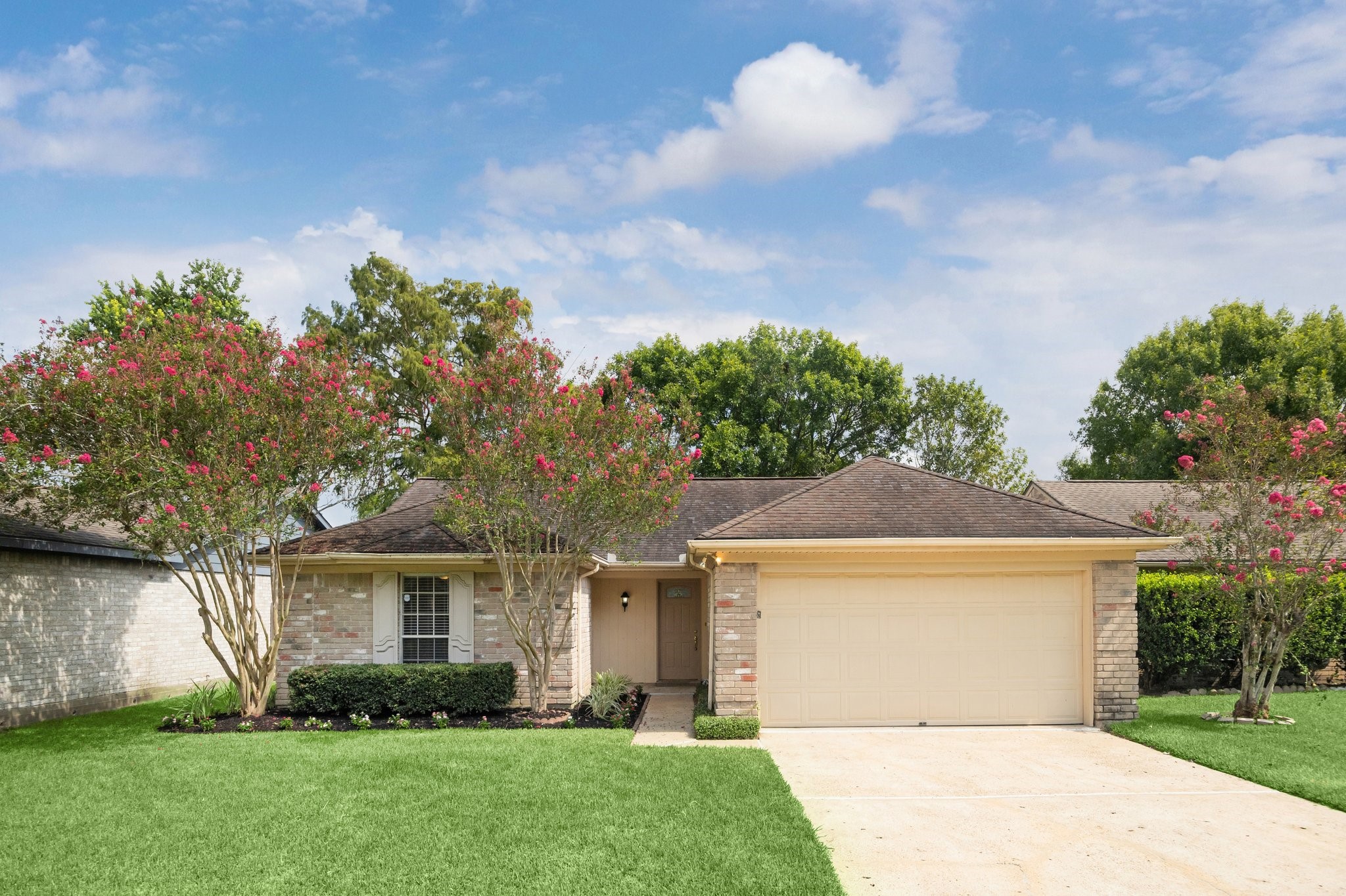 a front view of a house with a garden and plants