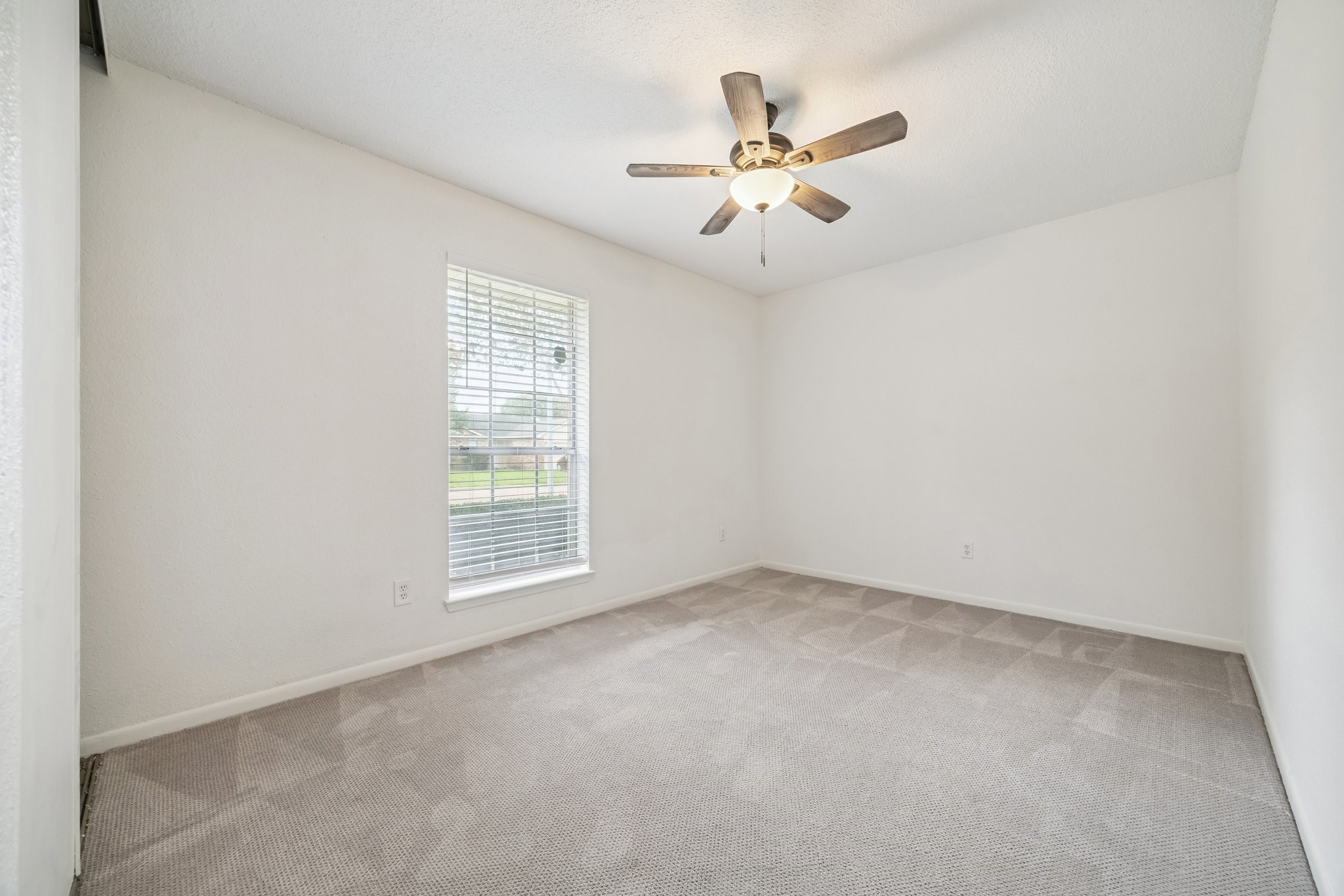 3923 Windmill Street Sugar Land, TX 77479 - Photo 12 of 16 an empty room with a window and a fan