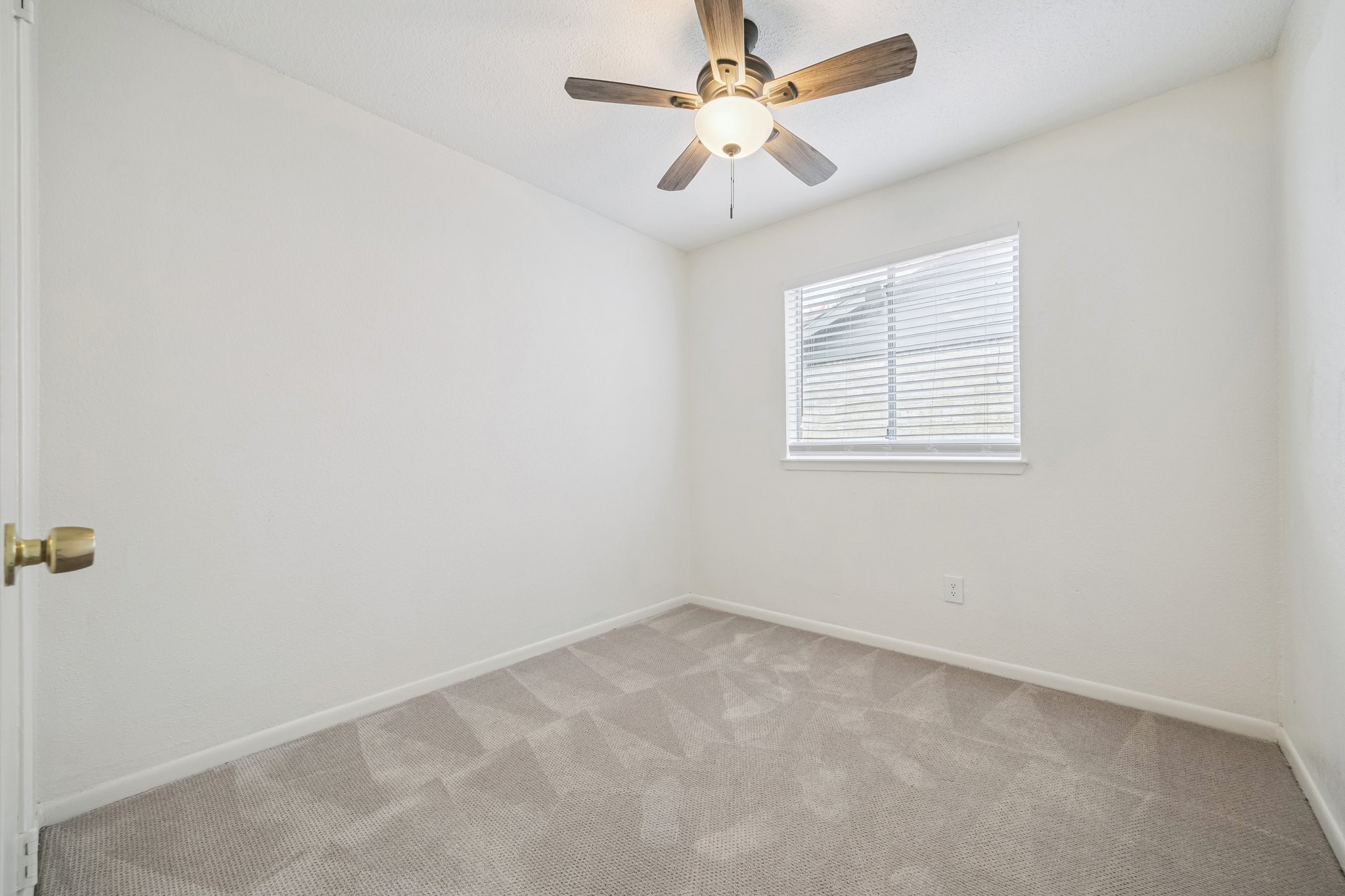 3923 Windmill Street Sugar Land, TX 77479 - Photo 13 of 16 an empty room with a window and a fan