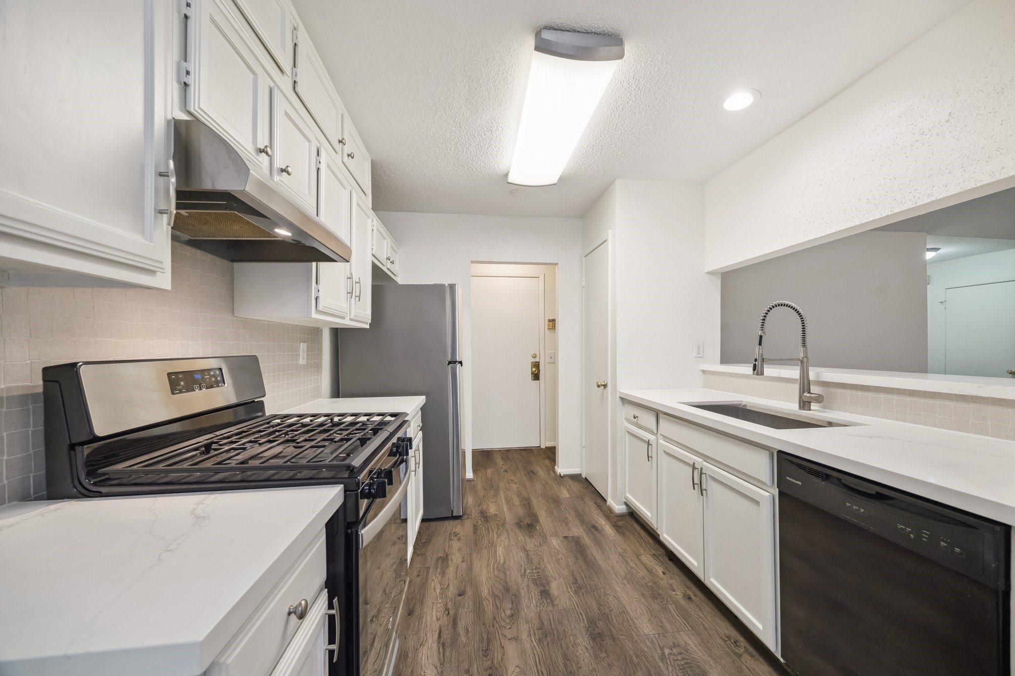 3923 Windmill Street Sugar Land, TX 77479 - Photo 7 of 16 a kitchen that has a sink and a stove