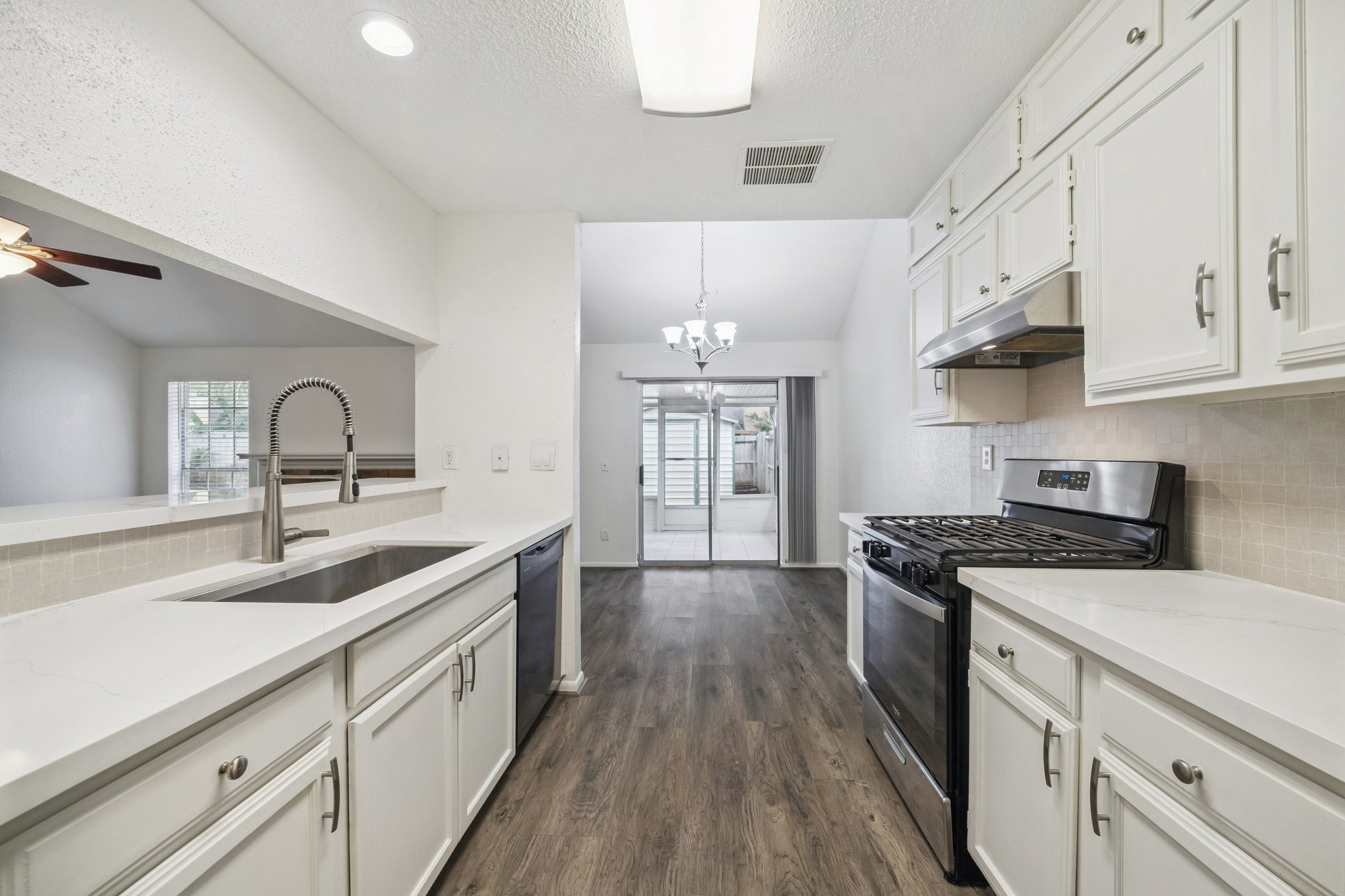 3923 Windmill Street Sugar Land, TX 77479 - Photo 8 of 16 a kitchen with stainless steel appliances granite countertop a sink stove and cabinets