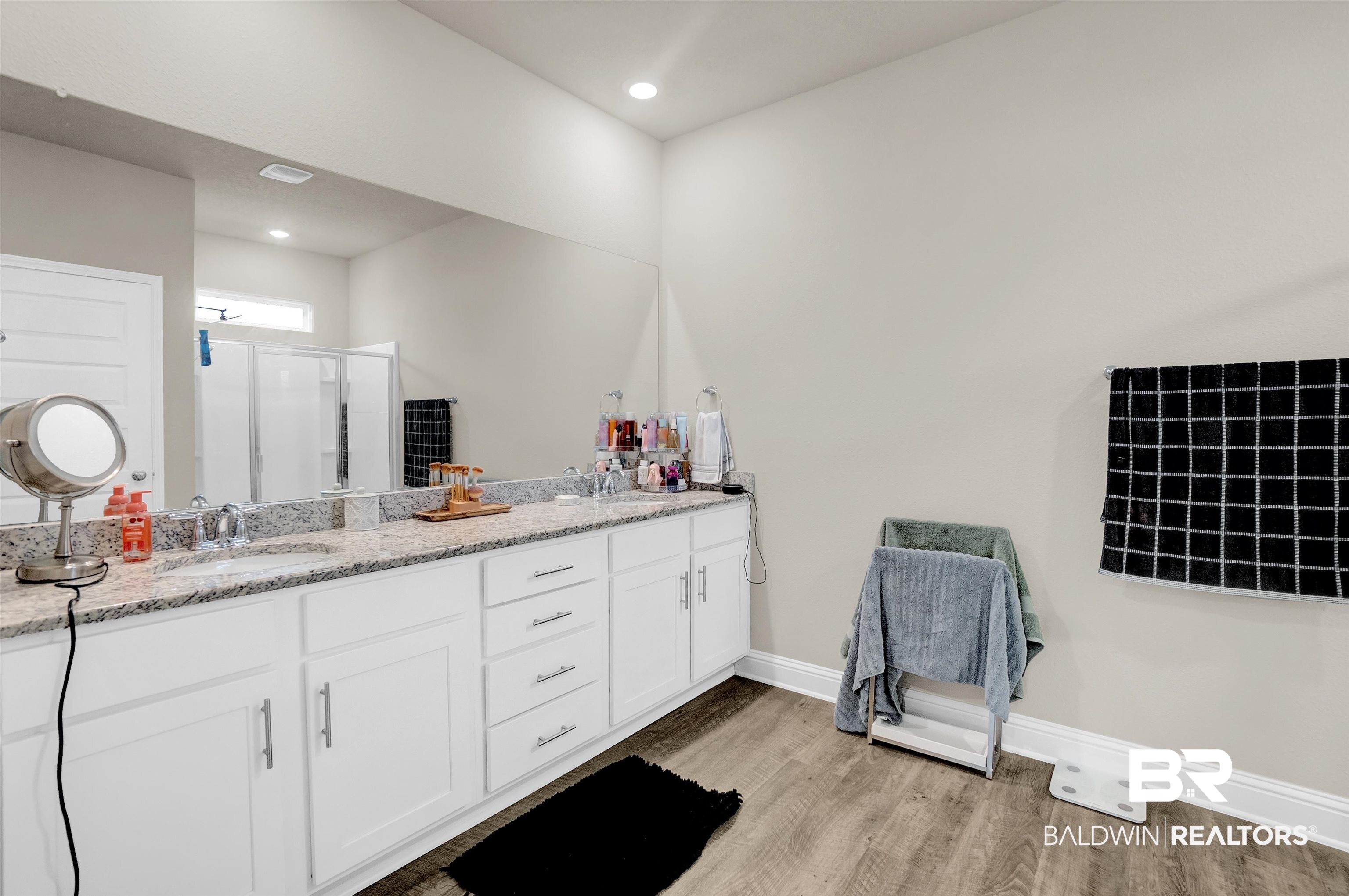 31671 Memphis Loop Daphne, AL 36527 - Photo 28 of 51 Full bath with a stall shower, a sink, wood finished floors, baseboards, and double vanity