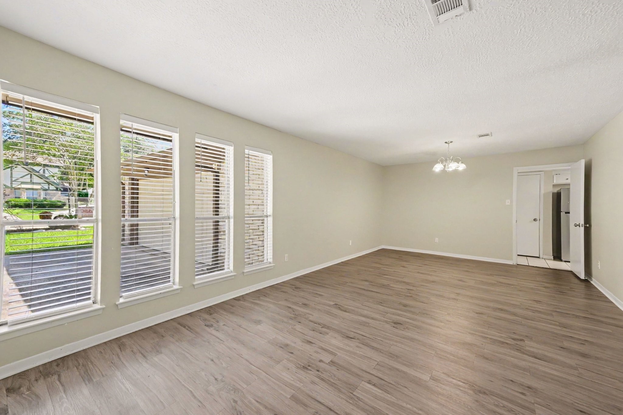 17419 Cassina Drive Spring, TX 77388 - Photo 6 of 35 a view of an empty room with wooden floor and a window
