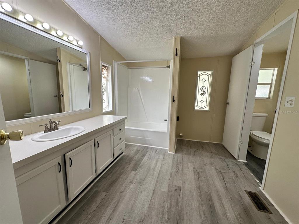 5920 Southwest 62nd Place Ocala, FL 34474 - Photo 16 of 20 a spacious bathroom with a double vanity sink and a mirror