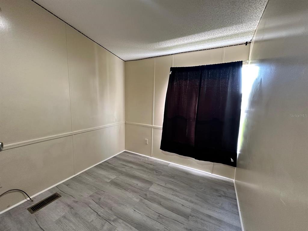 5920 Southwest 62nd Place Ocala, FL 34474 - Photo 17 of 20 an empty room with wooden floor