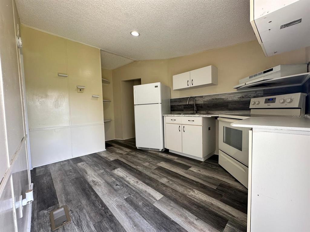 5920 Southwest 62nd Place Ocala, FL 34474 - Photo 19 of 20 a kitchen with a stove and a refrigerator