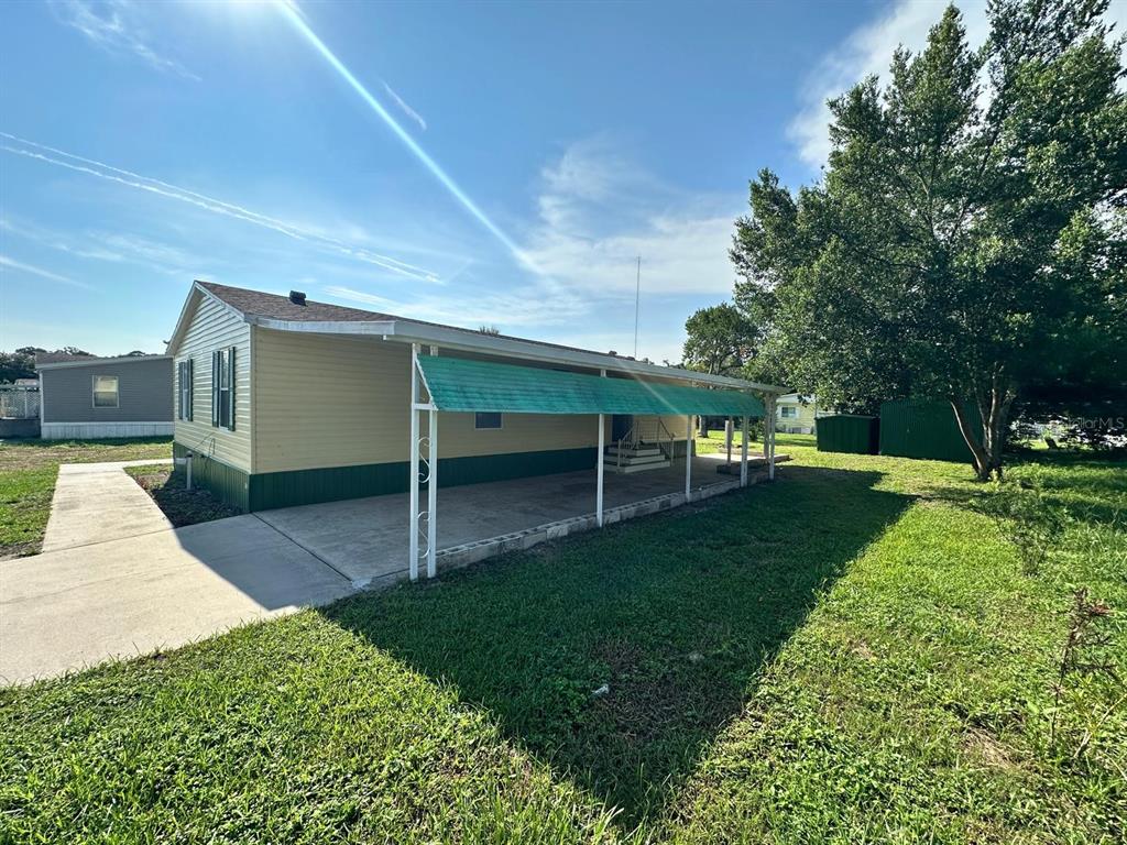 5920 Southwest 62nd Place Ocala, FL 34474 - Photo 2 of 20 a front view of a house with a yard and trees
