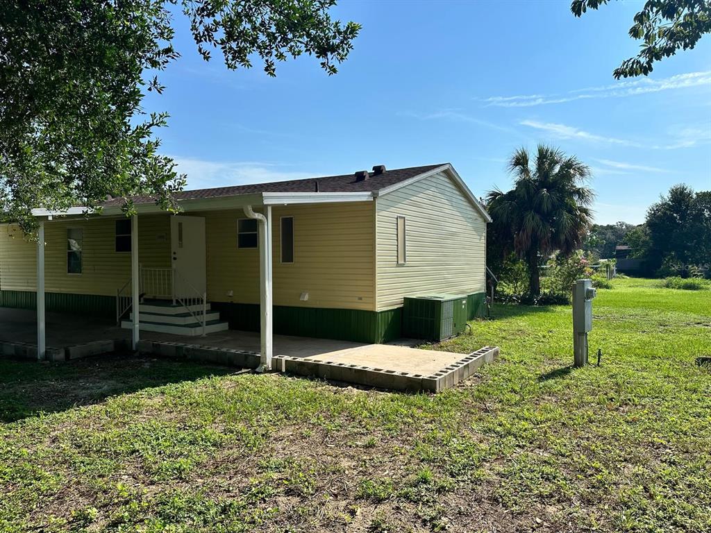 5920 Southwest 62nd Place Ocala, FL 34474 - Photo 5 of 20 a backyard of a house with potted plants and large tree