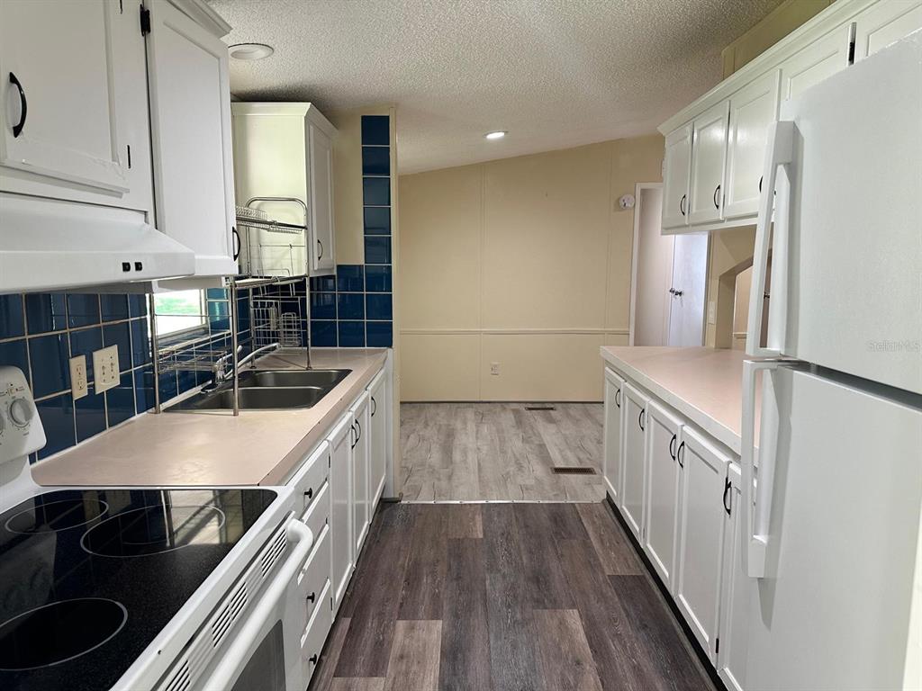 5920 Southwest 62nd Place Ocala, FL 34474 - Photo 7 of 20 a kitchen with a sink stove and cabinets