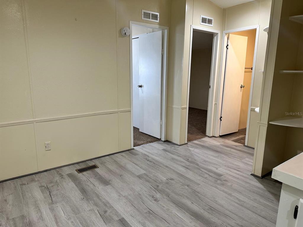 5920 Southwest 62nd Place Ocala, FL 34474 - Photo 8 of 20 a view of an empty room with wooden floor and a window