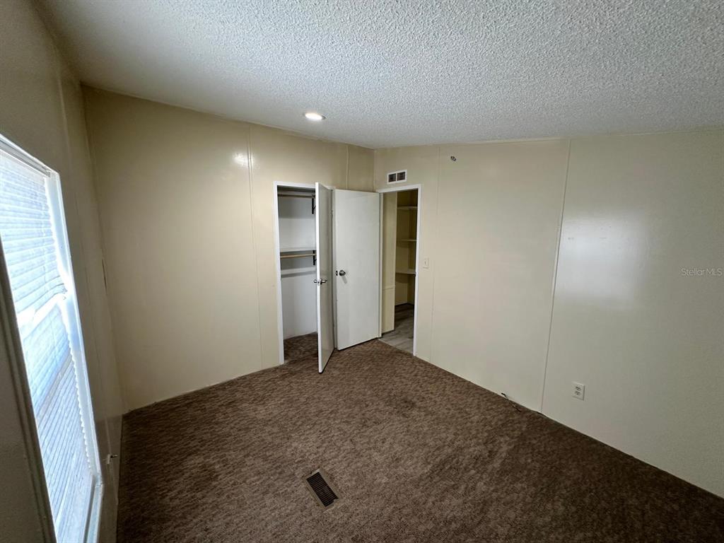 5920 Southwest 62nd Place Ocala, FL 34474 - Photo 10 of 20 an empty room with a closet and a window
