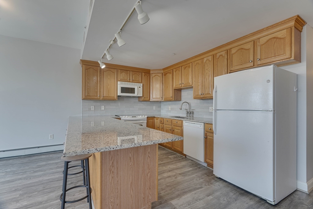 a kitchen with stainless steel appliances granite countertop a refrigerator sink and cabinets