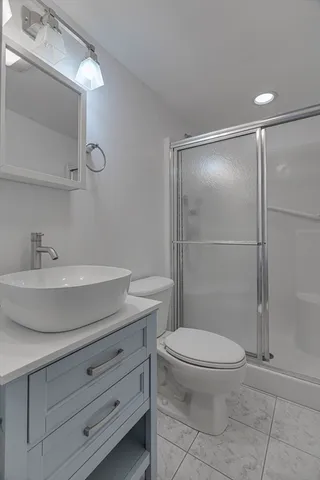 a bathroom with a toilet a sink and shower