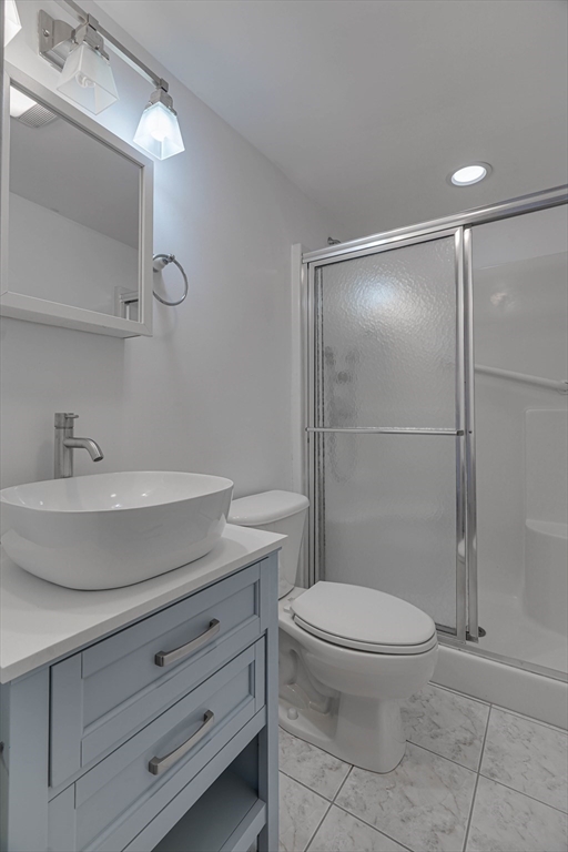 168 Humphrey Street, Unit 2 Swampscott, MA 01907 - Photo 19 of 26 a bathroom with a toilet a sink and shower