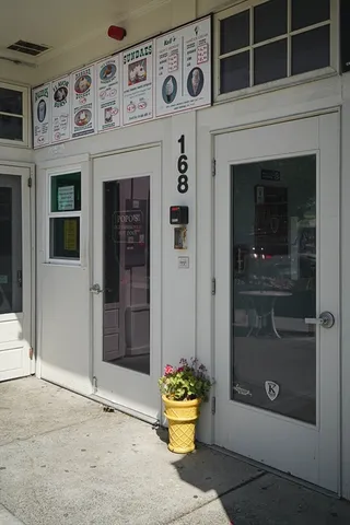 a front view of a house with outdoor space and seating space
