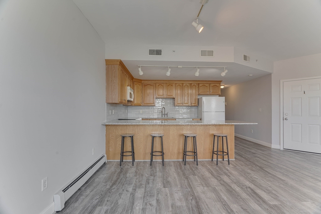 168 Humphrey Street, Unit 2 Swampscott, MA 01907 - Photo 4 of 26 a room with stainless steel appliances a kitchen island hardwood floor and a sink