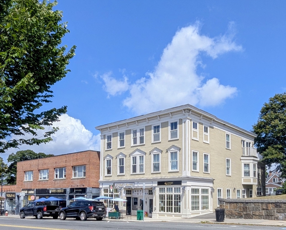 168 Humphrey Street, Unit 2 Swampscott, MA 01907 - Photo 5 of 26 a view of a building with lot of cars parked on the road