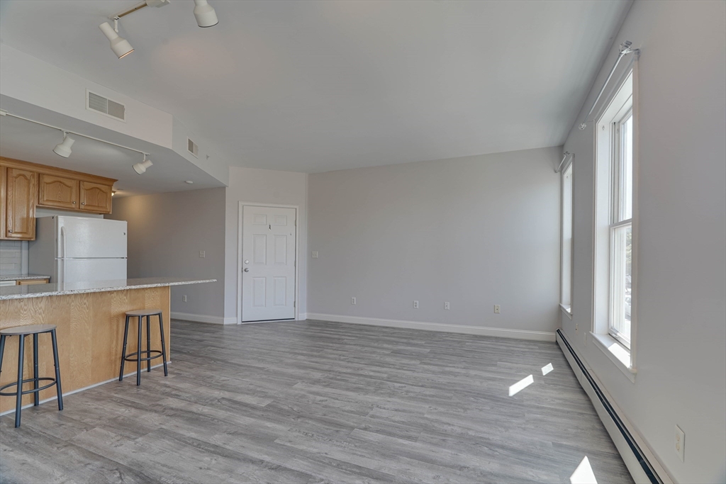 168 Humphrey Street, Unit 2 Swampscott, MA 01907 - Photo 7 of 26 a view of kitchen and wooden floor