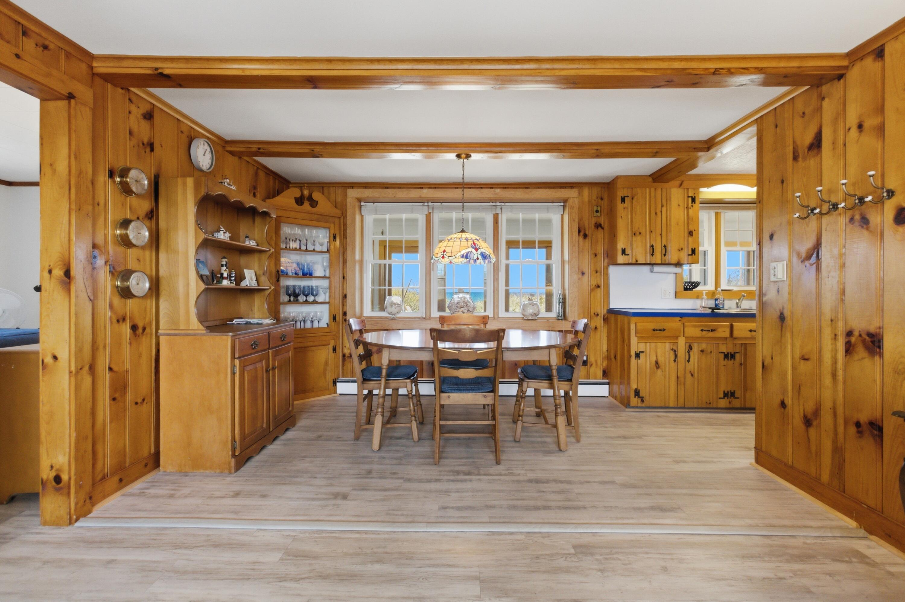 185 Phillips Road Sagamore Beach, MA 02562 - Photo 11 of 37 a view of a dining room with furniture and chandelier