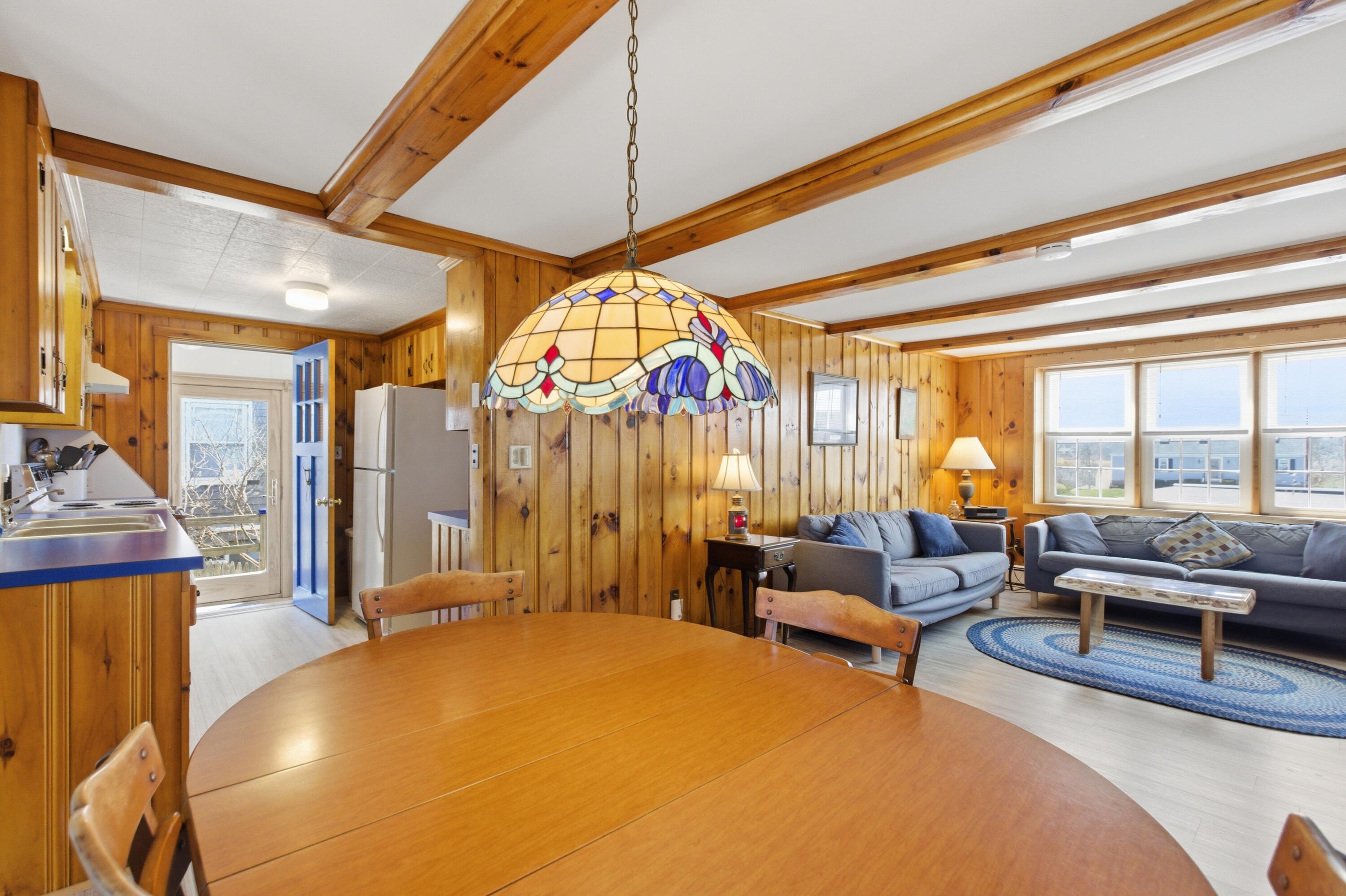 185 Phillips Road Sagamore Beach, MA 02562 - Photo 12 of 37 a living room with furniture a rug and a large window