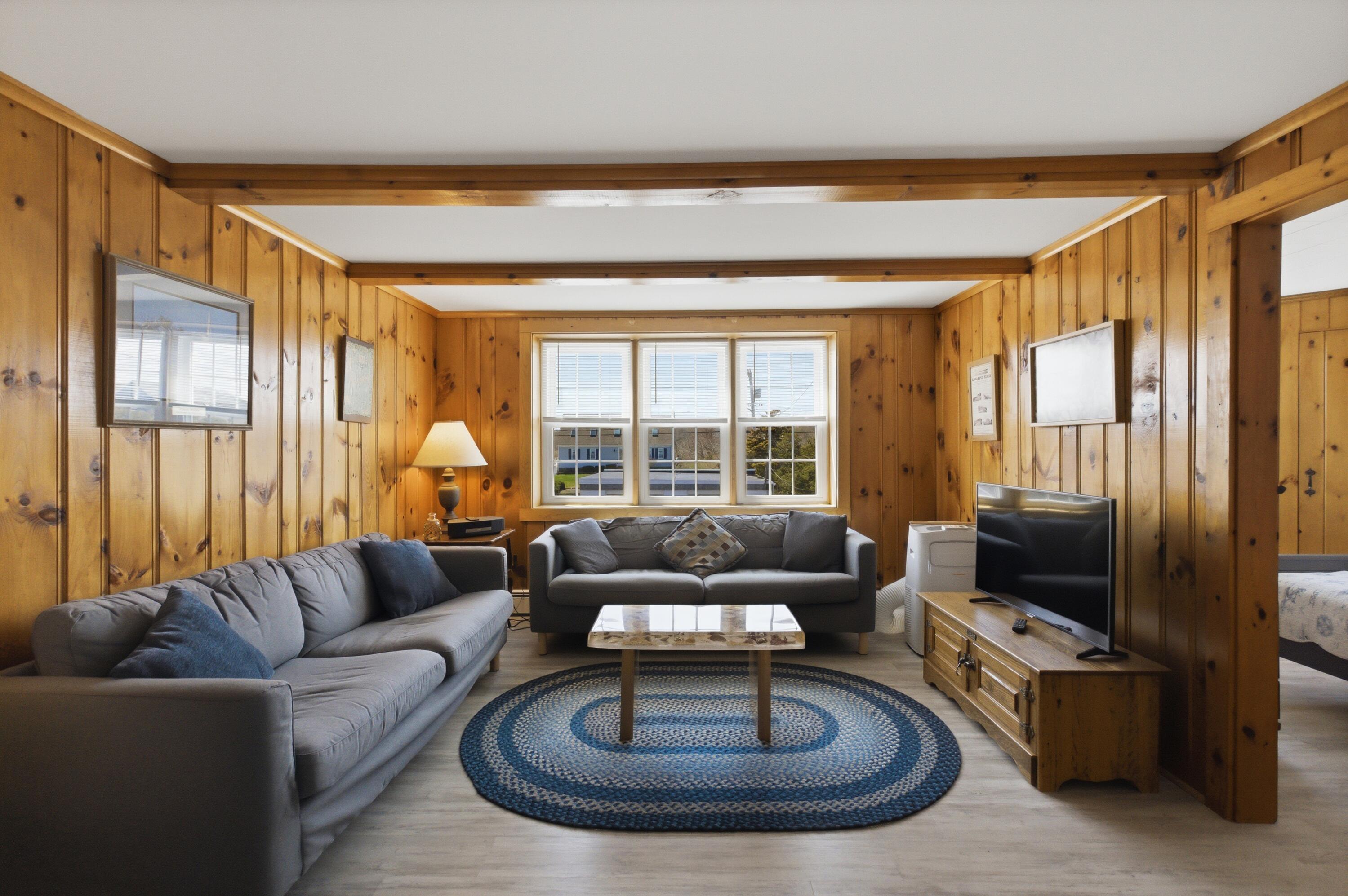 185 Phillips Road Sagamore Beach, MA 02562 - Photo 13 of 37 a living room with furniture and a flat screen tv