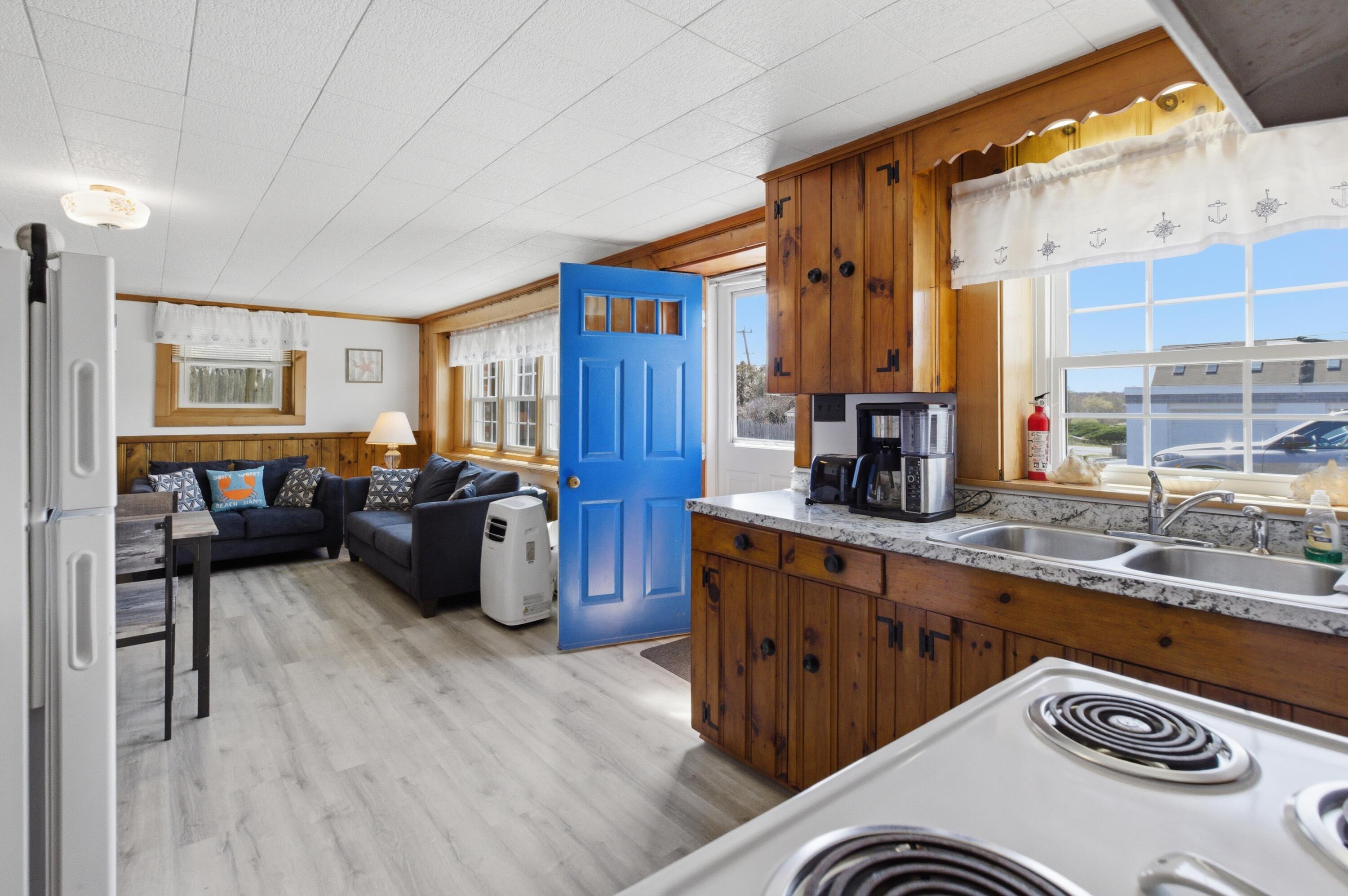 185 Phillips Road Sagamore Beach, MA 02562 - Photo 28 of 37 a kitchen with a sink a stove and chairs