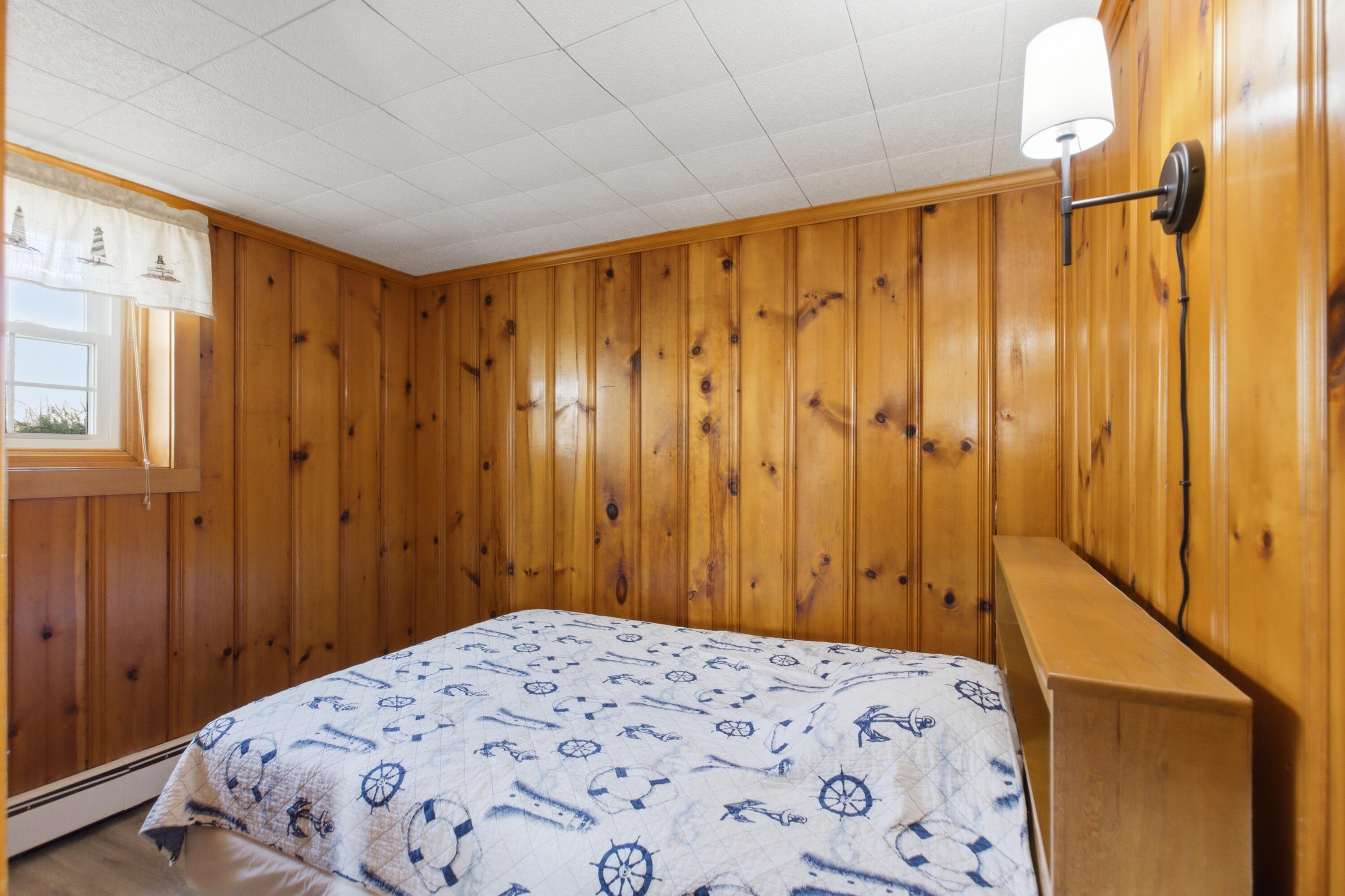 185 Phillips Road Sagamore Beach, MA 02562 - Photo 29 of 37 a bedroom with a bed and a window