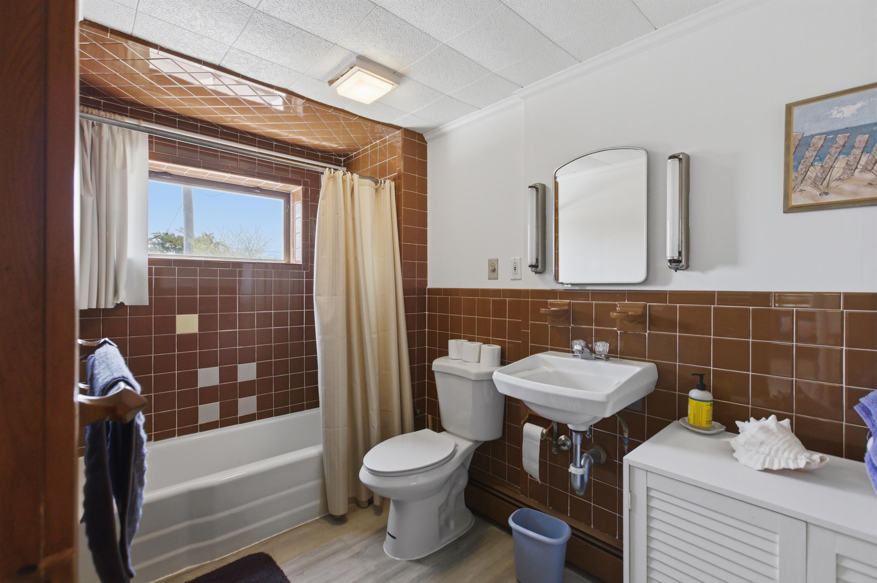 185 Phillips Road Sagamore Beach, MA 02562 - Photo 30 of 37 a bathroom with a sink a toilet and bathtub