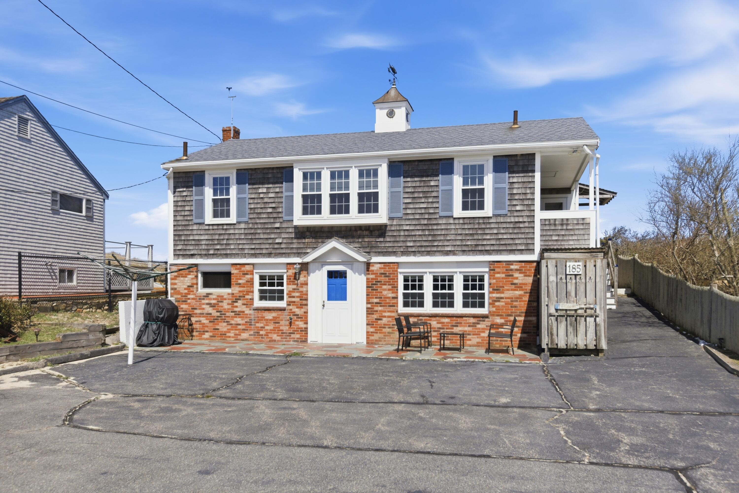 185 Phillips Road Sagamore Beach, MA 02562 - Photo 6 of 37 a front view of a house with a yard