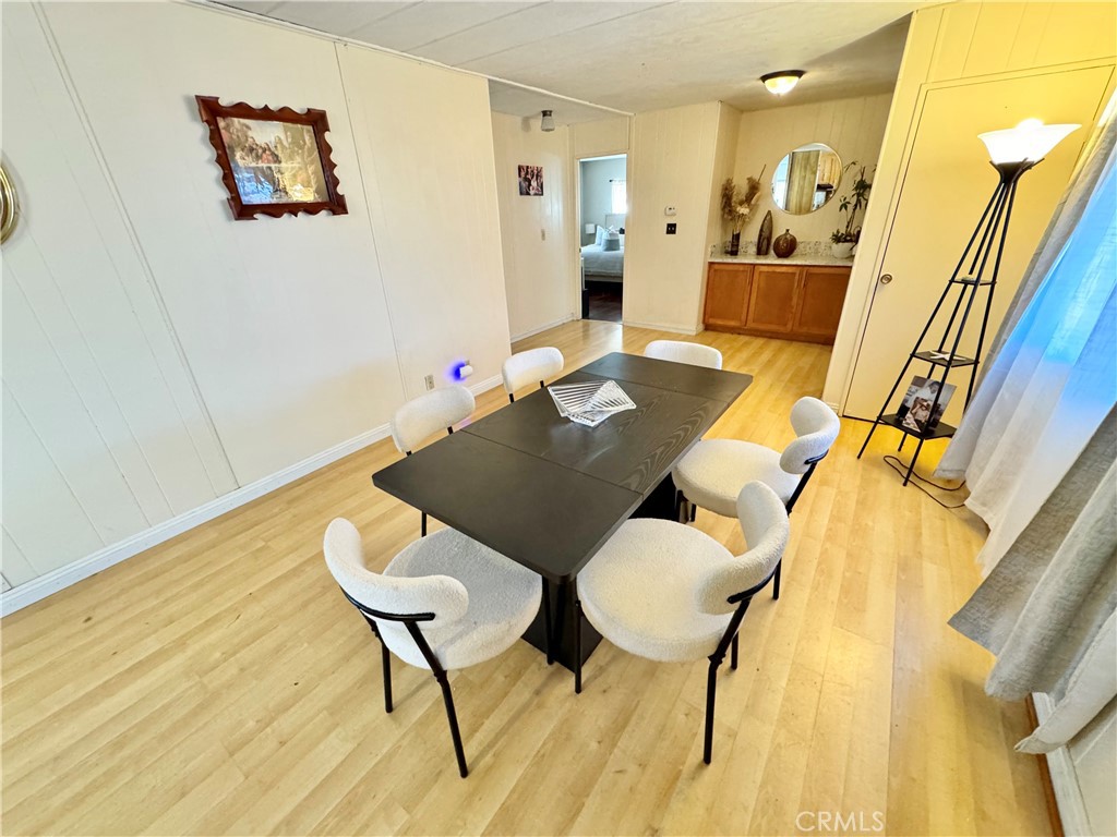 23301 Ridge Rte Drive, Unit 109 Laguna Hills, CA 92653 - Photo 35 of 46 a view of a dining room with furniture and wooden floor