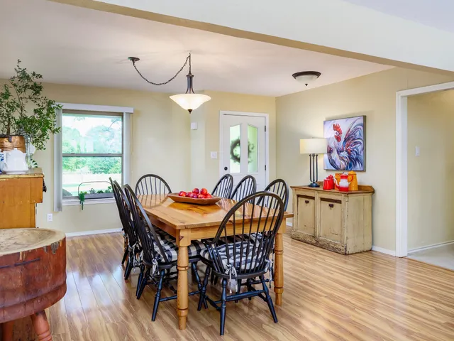a living room with furniture a flat screen tv and a window